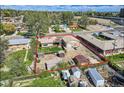 Aerial view showcases the property's layout, including the home, detached garage, and fenced yard at 4835 Harlan St, Wheat Ridge, CO 80033