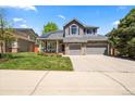 Charming two-story home featuring a stone facade, well-manicured lawn, and a spacious two-car garage at 2019 Clipper Dr, Lafayette, CO 80026