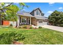 Charming two-story home with a stone facade, well-manicured lawn, and a spacious two-car garage at 2019 Clipper Dr, Lafayette, CO 80026