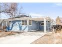 The side of this home features large windows, a carport and a well-maintained yard at 1825 S Adams St, Denver, CO 80210