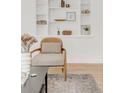 Close-up of living room decor, including accent chair, area rug, and built-in shelves at 1825 S Adams St, Denver, CO 80210