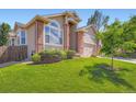 Well-maintained lawn and landscaping complement this charming two-story home's exterior at 22436 E Maplewood Pl, Aurora, CO 80015