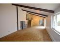 Spacious living room with vaulted ceilings and exposed beams, leading to a staircase at 8450 Mason Cir, Westminster, CO 80031