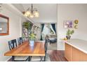 Cozy dining room with hardwood floors leading to an open floor plan and lots of natural light at 3312 Meadow Ave, Broomfield, CO 80020