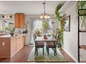 Open dining room with a view of the backyard, lots of plants, and wooden dining table at 3312 Meadow Ave, Broomfield, CO 80020
