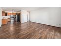 Galley kitchen with wood cabinets and stainless steel appliances at 300 S Clinton St # 10C, Denver, CO 80247