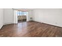 Bright living room with laminate flooring and sliding door to balcony at 300 S Clinton St # 10C, Denver, CO 80247