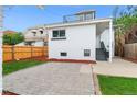 Back exterior of home with a rooftop deck, and a well-kept yard with pavers and grass at 2767 W 38Th Ave, Denver, CO 80211
