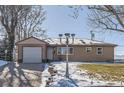 Charming ranch home with attached garage and snowy front yard at 5421 S Sherman St, Littleton, CO 80121