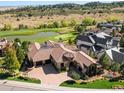 Breathtaking aerial view of the home on a golf course with mountain views at 7188 Raphael Ln, Littleton, CO 80125