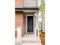Close-up of the front door with modern hardware and clear house number. Inviting entrance at 8917 Yates Dr, Westminster, CO 80031