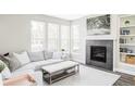 Bright living room featuring a cozy fireplace, large windows, and stylish decor for comfortable living at 8917 Yates Dr, Westminster, CO 80031