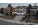 Beautiful two-story home with manicured landscaping, a gray exterior, and inviting curb appeal at 4930 Laurelglen Ln, Highlands Ranch, CO 80130