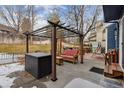 Outdoor patio with pergola and grill, perfect for hosting barbecues and enjoying the backyard at 16200 Quarry Hill Dr, Parker, CO 80134