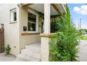 Close-up of front porch with brick and tan trim covered in a lush green vine facade at 416 W 3Rd Ave, Denver, CO 80223