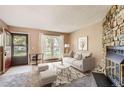 Virtually staged living room with entryway and fireplace at 1342 S Idalia St, Aurora, CO 80017