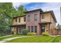 Attractive townhouse with a combination of brick and siding, with a grassy lawn and walkway to the entrance at 1916 S Elati St, Denver, CO 80223