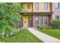 Inviting front of home featuring a well-manicured lawn and a charming walkway leading to the front door at 1916 S Elati St, Denver, CO 80223