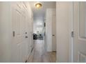 Bright hallway featuring wood floors and multiple doors leading to different rooms in the house at 4437 Cornish Way, Denver, CO 80239