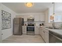 Well-lit kitchen featuring stainless steel appliances, white cabinets, and marble countertops at 4437 Cornish Way, Denver, CO 80239