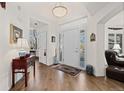 Bright entryway with hardwood floors, white walls, and an elegant chandelier that compliments a lovely foyer at 1011 S Valentia St # 121, Denver, CO 80247