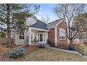 Inviting two-story home boasts a blend of neutral siding and brick, complemented by mature trees and a well-manicured lawn at 1011 S Valentia St # 121, Denver, CO 80247