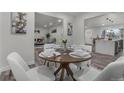 A beautifully staged dining room with modern decor and plenty of natural light at 2203 S Harlan St, Denver, CO 80227