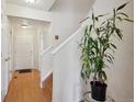 Light and bright entryway with hardwood floors and staircase at 9673 Ironton St, Commerce City, CO 80022