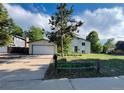 Beautiful home featuring a well-maintained lawn, mature trees, and inviting curb appeal at 15908 E Flora Pl, Aurora, CO 80013