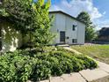 Exterior shot of a two-story home with brick accents and mature landscaping at 15908 E Flora Pl, Aurora, CO 80013