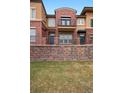 Attractive townhouse with brick facade, balcony and landscaped front yard at 8962 E Otero Pl, Centennial, CO 80112