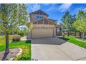Charming two-story home featuring a two-car garage, stone accents, and a well-manicured front lawn at 24316 E Ottawa Ave, Aurora, CO 80016