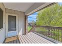 A welcoming balcony with wood floors offers views of community greenery and plenty of sunlight at 3663 S Sheridan Blvd # J12, Denver, CO 80235