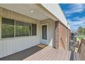 Exterior view of front door and deck with a welcome mat at 3663 S Sheridan Blvd # J12, Denver, CO 80235