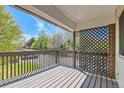 View of the outdoor deck with wood railings, a lattice privacy screen, and open space at 3663 S Sheridan Blvd # J12, Denver, CO 80235
