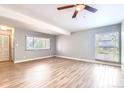 Bright living room with wood floors and natural light streaming through the windows at 3663 S Sheridan Blvd # J12, Denver, CO 80235
