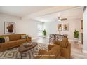 Bright living room with wood floors, neutral decor, and comfortable seating and dining spaces at 3663 S Sheridan Blvd # J12, Denver, CO 80235