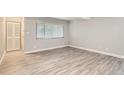 Bright living room with neutral walls, laminate flooring, and natural light at 3663 S Sheridan Blvd # J12, Denver, CO 80235