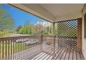 Covered patio with wooden deck overlooking the neighborhood at 3663 S Sheridan Blvd # J12, Denver, CO 80235