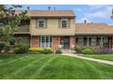 Charming townhome with a well-manicured lawn and inviting brick facade at 9031 E Amherst Dr # D, Denver, CO 80231