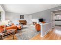 Inviting living room with a cozy fireplace, neutral colors and hardwood flooring at 9031 E Amherst Dr # D, Denver, CO 80231