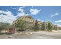 Attractive apartment complex with well-maintained landscaping and beautiful blue sky, perfect for comfortable living at 13456 Via Varra # 406, Broomfield, CO 80020