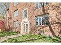 Charming brick apartment building entrance with detailed stonework and flourishing greenery, adding elegance and warmth at 1410 Vine St # 3, Denver, CO 80206
