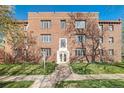 Classic brick apartment building with well-maintained lawn and garden beds, embodying timeless charm and curb appeal at 1410 Vine St # 3, Denver, CO 80206