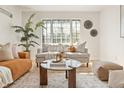 Bright living room with large window, comfortable seating, and stylish decor providing a cozy and inviting atmosphere at 1410 Vine St # 3, Denver, CO 80206
