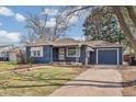Blue home with a well-manicured lawn, a single car garage and sidewalk leading to the front door at 2718 S Hazel Ct, Denver, CO 80236