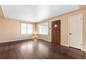 Living room featuring hardwood floors, a large window, and neutral paint throughout at 2718 S Hazel Ct, Denver, CO 80236