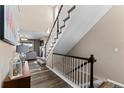 Inviting entryway with hardwood floors and a staircase leading to the upper level of the home at 15100 Gaylord St, Thornton, CO 80602