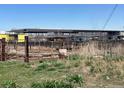 View of land showing a large building construction site and rusted metal fencing at 15200 Holly St, Thornton, CO 80602
