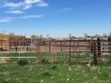 Exterior view of the property with fencing and hay bales in the background at 15200 Holly St, Thornton, CO 80602